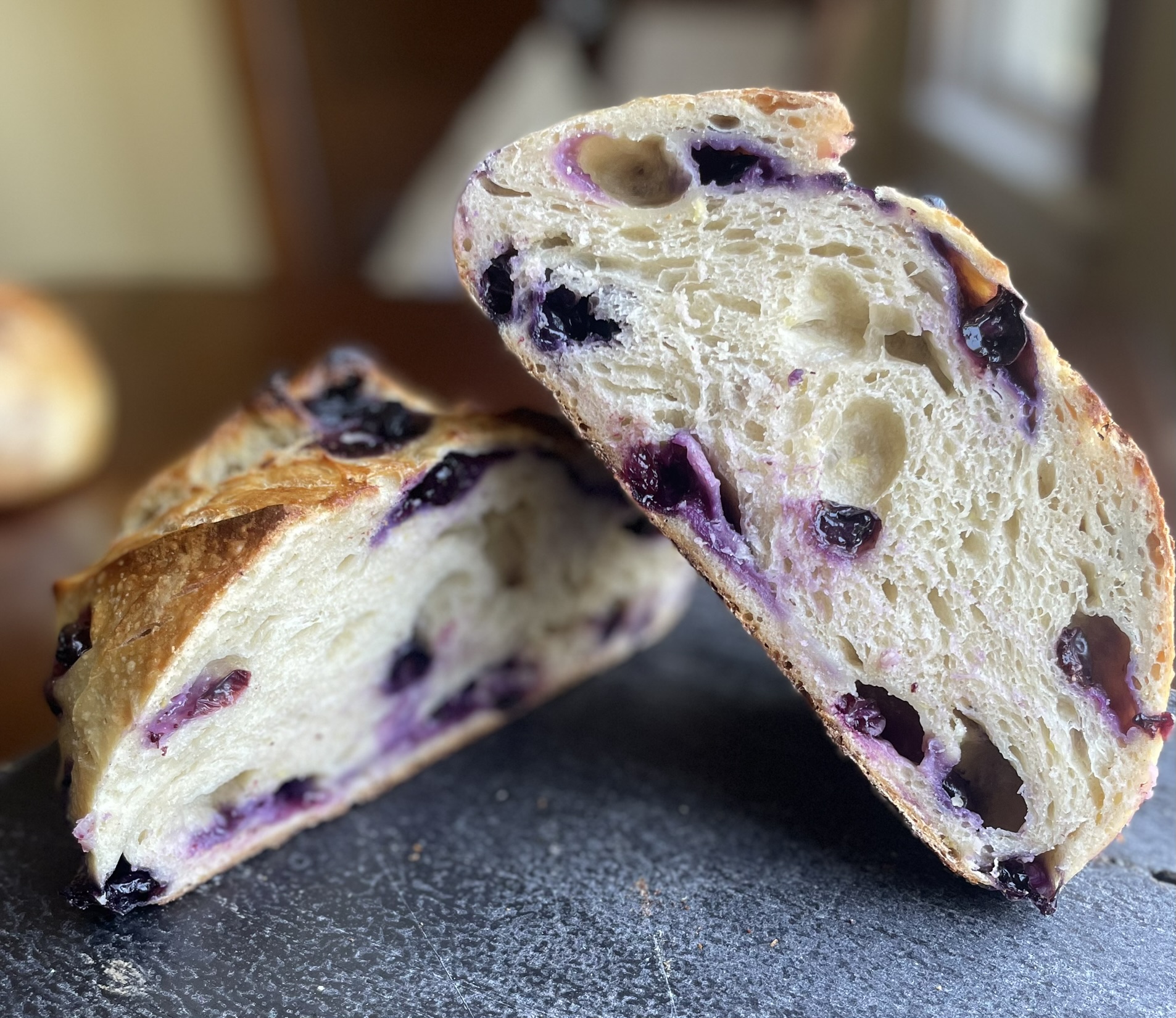 Blueberry lemon sourdough cross section showing berry-filled crumb