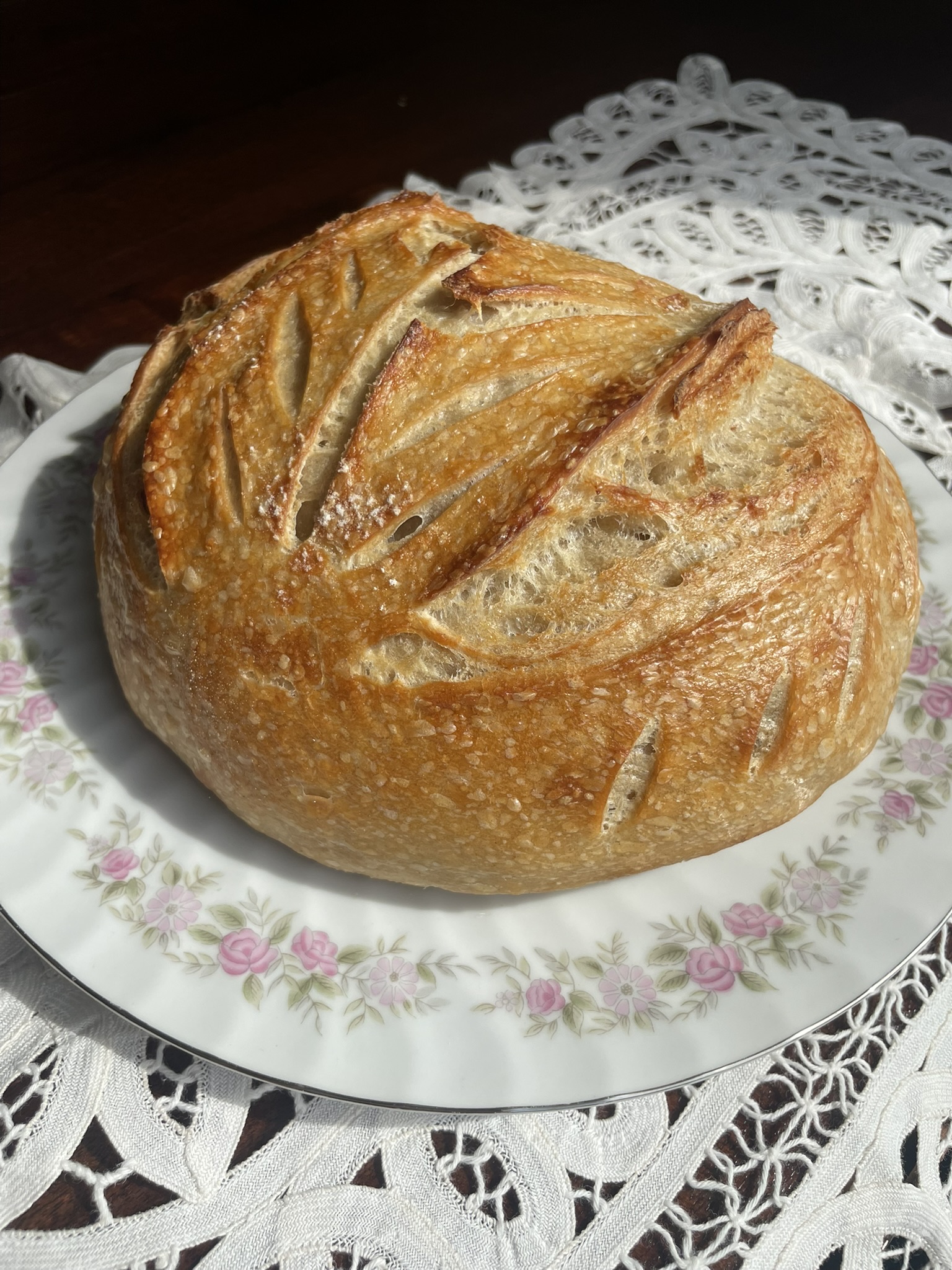 Classic sourdough whole loaf on china plate