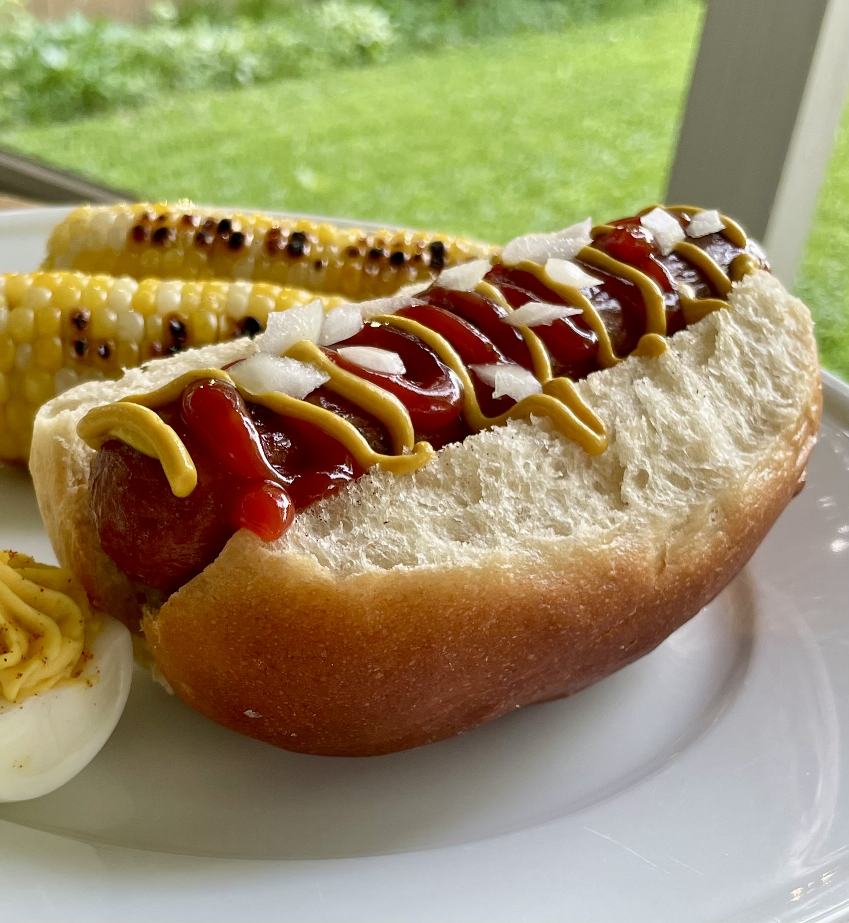 Hotdog nestled in a Wild Nunn sourdough bun with toppings